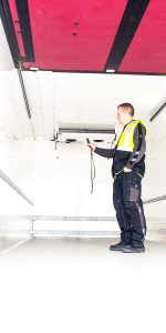 man in high vis jacket checking device
