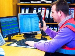 man answering emails and phone