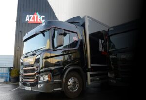 scania truck outside aztec logo sign