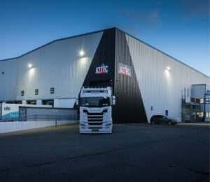aztec scania truck outside offices of aztec logistics at night
