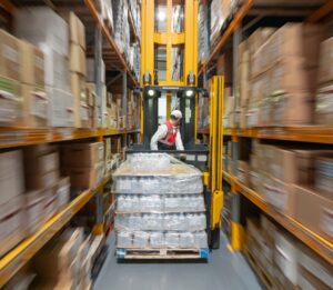 forklift pallet truck driver carrying load